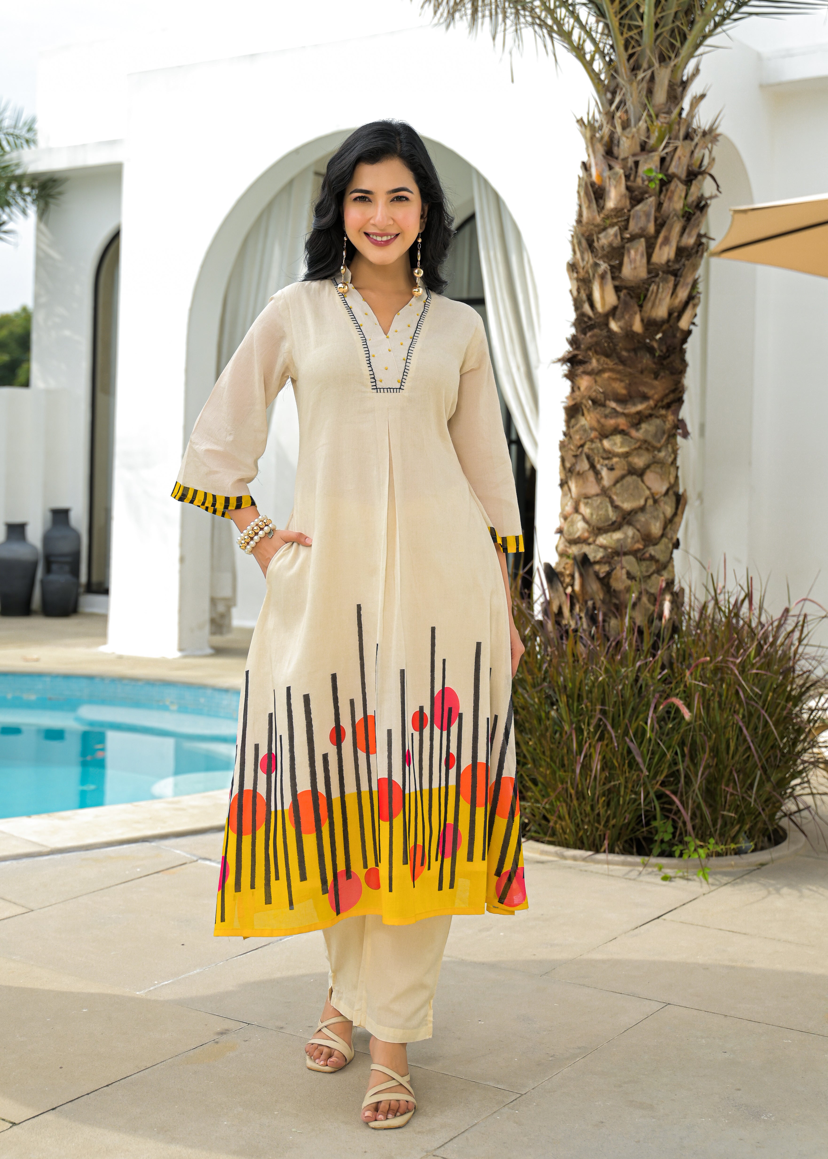 Beige Cotton A-Line Kurta Set with Abstract Yellow & Red Printed Hem – Festive & Casual Wear for Women